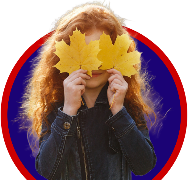 A girl holding leaves over her eyes